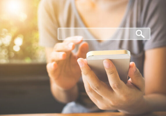 Women use smartphones to find what they are interested in. Searching information data on internet networking concept